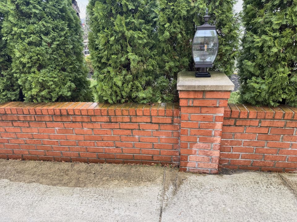 Brick wall pillar and driveway mid wash showing the clean line