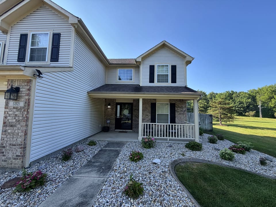Cream vinyl home with a covered front porch and clean white trim