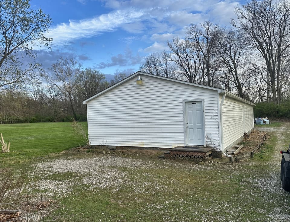 After: white vinyl outbuilding, washed clean