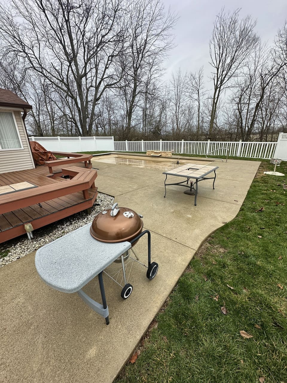 Back patio with a grill and seating after pressure washing