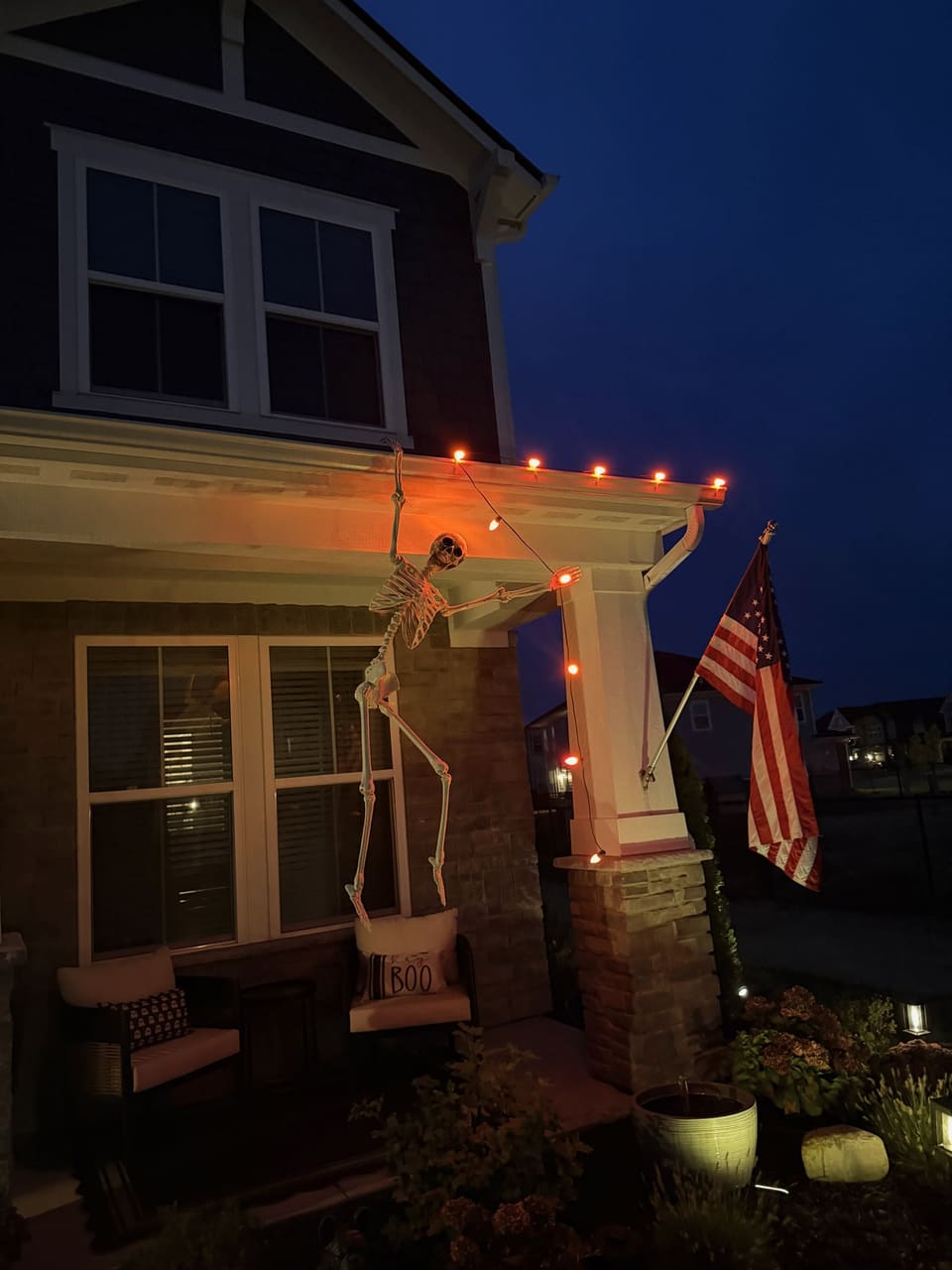 Front porch at night with permanent lights set to orange for Halloween