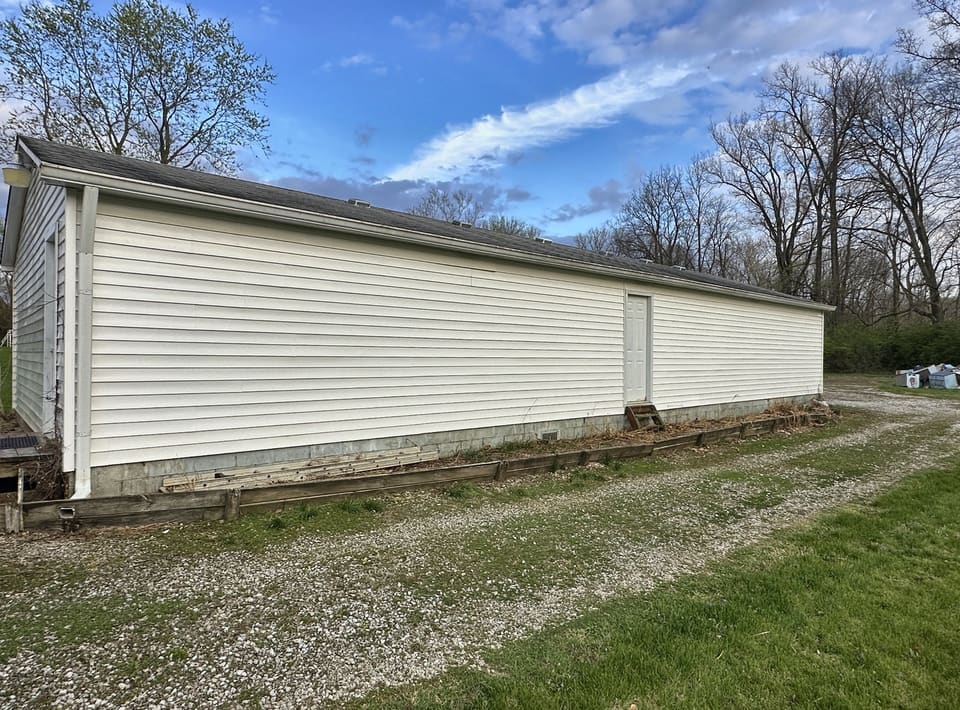 After: long white vinyl pole barn, washed clean