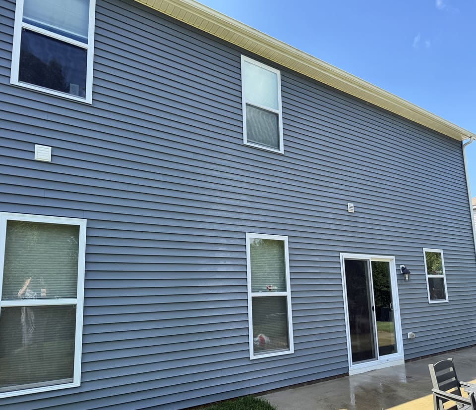 After: rear wall of blue gray vinyl siding, washed clean