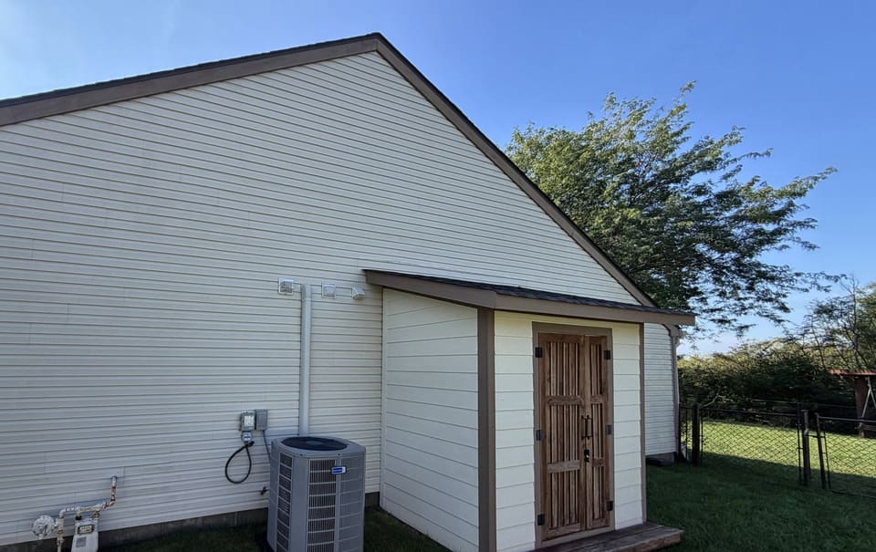 After: rear wall of a home with an attached shed, washed clean